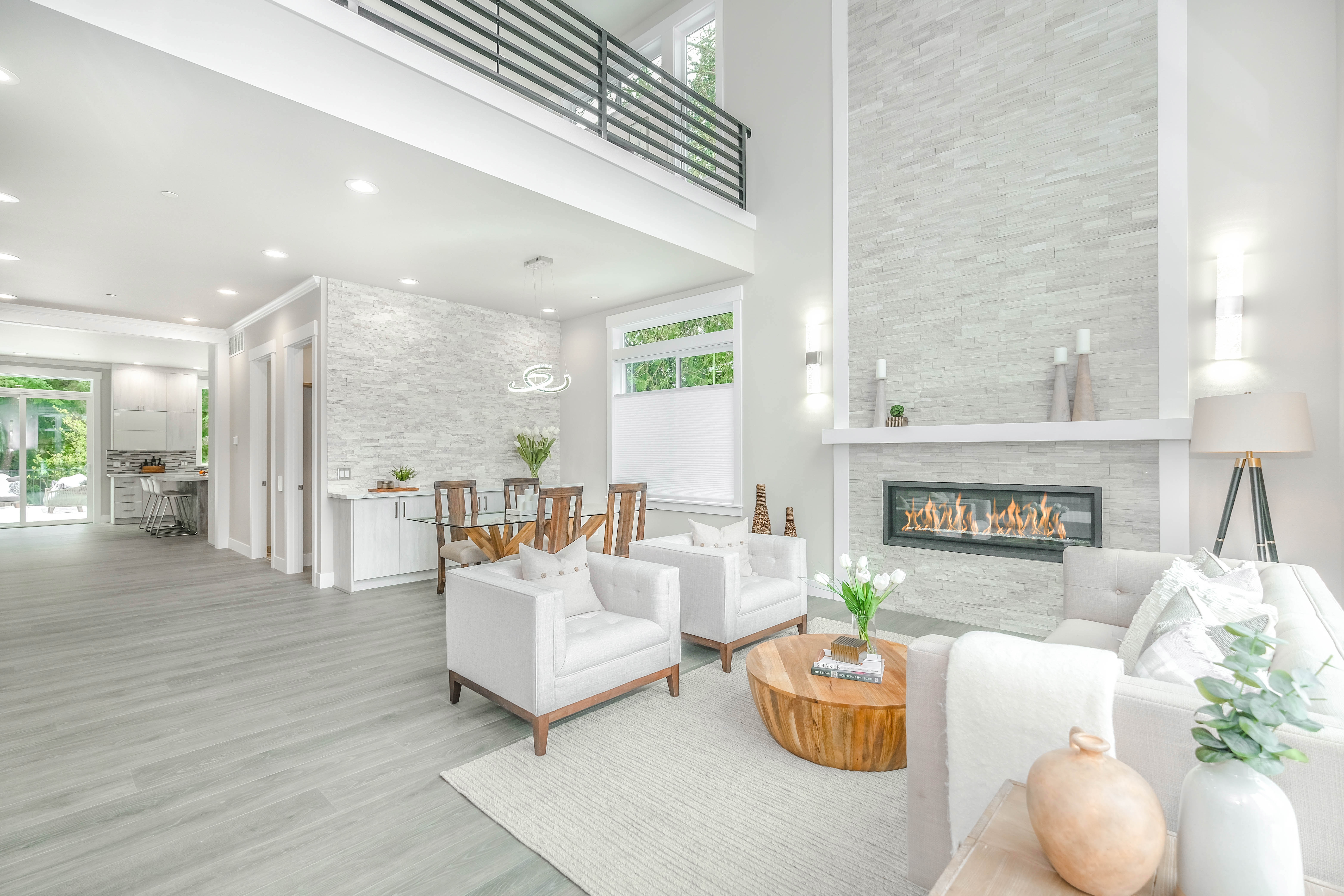  A comparison of open concept and traditional home designs. The image shows a modern open-concept living space with large windows, allowing natural light to flood the room. The absence of walls between the living room, kitchen, and dining area creates an airy feel and promotes socializing. On the other hand, a traditional home layout is depicted with separate rooms connected by hallways, providing privacy and better organization. The image highlights the choices homeowners face when deciding between the two designs, considering factors like house size, lifestyle differences, and personal preferences. It encourages making an informed decision and seeking professional advice for the best layout that suits individual needs.